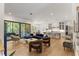 Open-concept living room features hardwood floors, modern lighting, and access to an outdoor deck at 8420 Bells Lake Rd, Apex, NC 27539