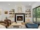 Bright living room features a fireplace, hardwood floors, and access to the outdoor deck at 8420 Bells Lake Rd, Apex, NC 27539
