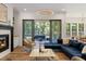 Cozy living room with fireplace, sliding doors to a screened porch, and comfortable seating at 8420 Bells Lake Rd, Apex, NC 27539