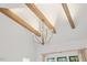 Bright living room featuring exposed beams, vaulted ceiling and elegant chandelier lighting at 8420 Bells Lake Rd, Apex, NC 27539