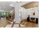 Bright office featuring modern desk, wooden floors, and glass paneled doors to the entry hall at 8420 Bells Lake Rd, Apex, NC 27539