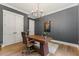 Stylish office featuring hardwood floors, modern chandelier, and functional wood desk at 8420 Bells Lake Rd, Apex, NC 27539