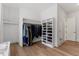 Spacious walk-in closet with custom shelving and hardwood floors at 8420 Bells Lake Rd, Apex, NC 27539