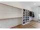 Spacious walk-in closet with custom shelving and hardwood flooring at 8420 Bells Lake Rd, Apex, NC 27539