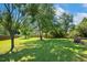 Spacious backyard with mature trees and a sprawling green lawn at 86 Basswood Cir, Willow Springs, NC 27592