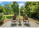 Landscaped backyard featuring a quaint seating area and well-manicured lawn at 86 Basswood Cir, Willow Springs, NC 27592
