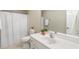 Bathroom with single sink vanity, neutral walls, and shower with curtain at 86 Basswood Cir, Willow Springs, NC 27592