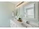 Bright bathroom featuring a double vanity with framed mirrors and fresh, light-colored walls at 86 Basswood Cir, Willow Springs, NC 27592