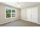 Bright bedroom with natural light, plush carpeting, and a spacious closet at 86 Basswood Cir, Willow Springs, NC 27592