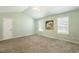 Spacious bedroom with a ceiling fan, carpet, and two windows for natural light at 86 Basswood Cir, Willow Springs, NC 27592