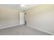Spacious bedroom featuring plush carpeting and a door leading to a hallway at 86 Basswood Cir, Willow Springs, NC 27592