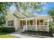 Charming single Gathering home showcasing a cozy porch with an American flag and lovely landscaping at 86 Basswood Cir, Willow Springs, NC 27592