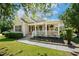 Inviting front porch with white railing, decorative plants, and classic shutters at 86 Basswood Cir, Willow Springs, NC 27592
