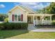 Charming home showcasing a cozy front porch with decorative plants and red shutters at 86 Basswood Cir, Willow Springs, NC 27592