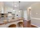 Bright, open kitchen with breakfast bar, complete with modern appliances and wood floors at 86 Basswood Cir, Willow Springs, NC 27592
