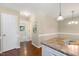 View of kitchen adjacent to dining area, featuring wood floors and light fixtures at 86 Basswood Cir, Willow Springs, NC 27592