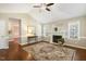 Cozy living room with hardwood floors, a fireplace, and natural lighting creating a warm ambiance at 86 Basswood Cir, Willow Springs, NC 27592