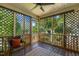 Serene screened-in porch with views of the lush, green landscape at 86 Basswood Cir, Willow Springs, NC 27592