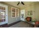 Inviting screened-in porch with wicker furniture and a ceiling fan for outdoor enjoyment at 86 Basswood Cir, Willow Springs, NC 27592