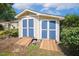 Outdoor shed with double doors, offering ample storage space, alongside the house at 86 Basswood Cir, Willow Springs, NC 27592