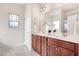 Bathroom featuring a double sink vanity with wood cabinets and tile flooring at 88 Longo Ln, Benson, NC 27504