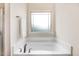 Close up of a bathtub with a window above it at 88 Longo Ln, Benson, NC 27504