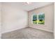 Bedroom featuring carpet flooring and a window at 88 Longo Ln, Benson, NC 27504