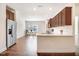 Open kitchen with dark cabinetry, stainless steel appliances, and eat-in dining area at 88 Longo Ln, Benson, NC 27504