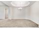 Living room with tray ceilings, chandelier, and neutral carpet flooring at 88 Longo Ln, Benson, NC 27504