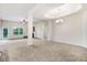 Spacious living room with carpeting and a tray ceiling with chandelier at 88 Longo Ln, Benson, NC 27504
