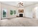 Carpeted living room featuring a fireplace, ceiling fan and natural light at 88 Longo Ln, Benson, NC 27504