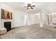 Spacious living room with a fireplace, columns, and a modern chandelier at 88 Longo Ln, Benson, NC 27504