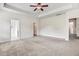 Expansive main bedroom with tray ceiling features neutral carpet and multiple doorways at 88 Longo Ln, Benson, NC 27504