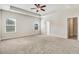 Spacious main bedroom featuring plush carpeting, two windows, and a ceiling fan at 88 Longo Ln, Benson, NC 27504