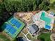 Aerial view showcasing the tennis courts, playground, pool and clubhouse at 917 Haddon Hall Dr, Apex, NC 27502