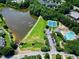 The aerial view highlights the neighborhood amenities, including a lake, tennis courts, and a swimming pool at 917 Haddon Hall Dr, Apex, NC 27502