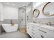 Luxurious bathroom featuring a soaking tub, glass-enclosed shower, and double vanity with marble countertop at 917 Haddon Hall Dr, Apex, NC 27502