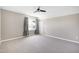 Spacious bedroom with neutral carpet, large window, and ceiling fan at 917 Haddon Hall Dr, Apex, NC 27502