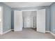 Bedroom features neutral carpet and paint, a walk-in closet, and a window view at 917 Haddon Hall Dr, Apex, NC 27502