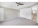 Large bedroom with gray carpet, double closets and view to the hallway at 917 Haddon Hall Dr, Apex, NC 27502