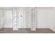 Walk-in closet with built-in shelving and storage behind a white panel door at 917 Haddon Hall Dr, Apex, NC 27502