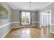 Formal dining room boasting lots of natural light, decorative trim and hardwood floors at 917 Haddon Hall Dr, Apex, NC 27502
