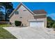 Exterior shot of a home with a garage, driveway, and backyard landscaping at 917 Haddon Hall Dr, Apex, NC 27502