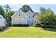 Charming home with a manicured lawn, mature trees, and a classic facade at 917 Haddon Hall Dr, Apex, NC 27502