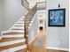 Inviting foyer with hardwood floors, staircase with rod iron spindles, and natural light at 917 Haddon Hall Dr, Apex, NC 27502