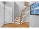Inviting foyer with beautiful hardwood floors, staircase with iron spindles, and a light gray wall at 917 Haddon Hall Dr, Apex, NC 27502