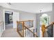 Upstairs landing area with decorative railing, light gray walls and view of bedroom at 917 Haddon Hall Dr, Apex, NC 27502