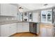 Well-appointed kitchen with stainless dishwasher and views to living room fireplace and large windows at 917 Haddon Hall Dr, Apex, NC 27502