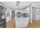 Modern kitchen featuring stainless appliances, granite countertops and light wood flooring at 917 Haddon Hall Dr, Apex, NC 27502