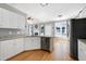 Stylish kitchen with stainless appliances, white cabinetry, and modern amenities overlooking the living room at 917 Haddon Hall Dr, Apex, NC 27502